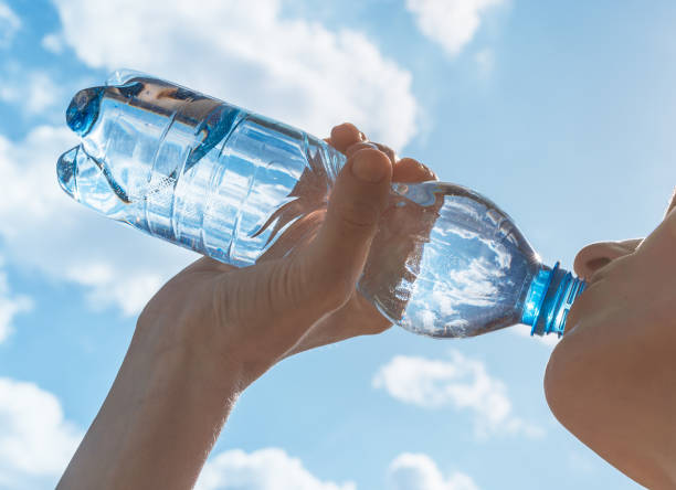 Woman drinking water after her workout.